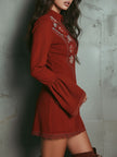 Red lace embroidered mini dress by FJØRNA, featuring intricate embroidery and a fitted silhouette for evening wear.