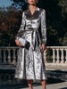 FJØRNA button-front belted midi coat dress for women, stylish dress with a tailored fit and classic design, shown on a model.
