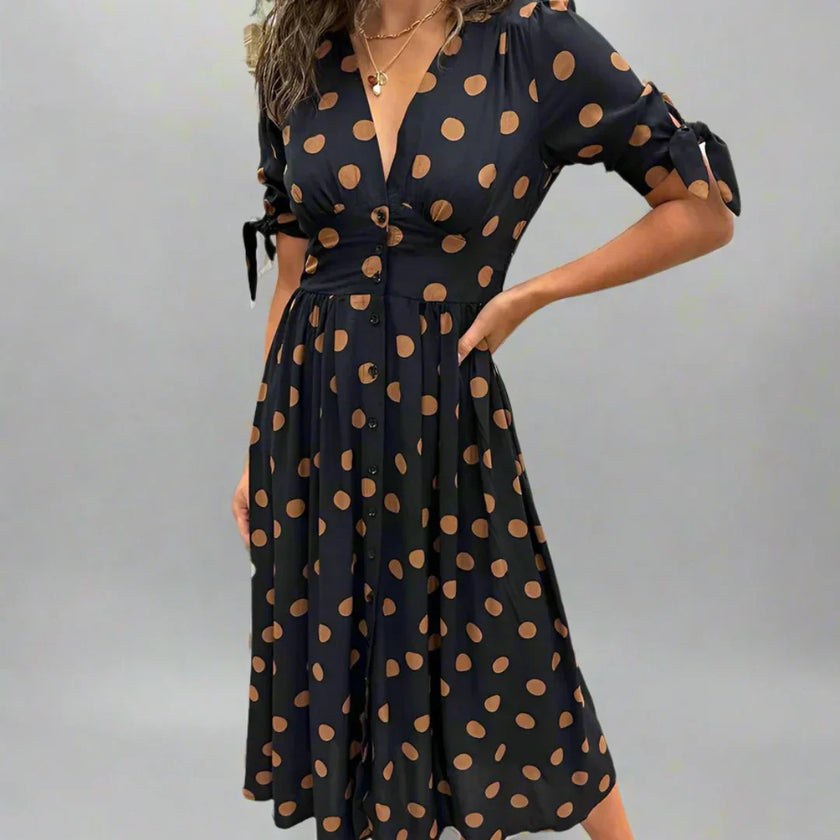 FJØRNA summer mini dress for women featuring a polka dot pattern and V-neck design, perfect for warm weather.