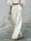 Cream textured lantern sleeve two-piece set for women by FJØRNA, featuring stylish pants and a matching top with lantern sleeves.