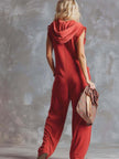 Raspberry red cotton hooded zip-front jumpsuit for women by FJØRNA, showing the full-length front view.