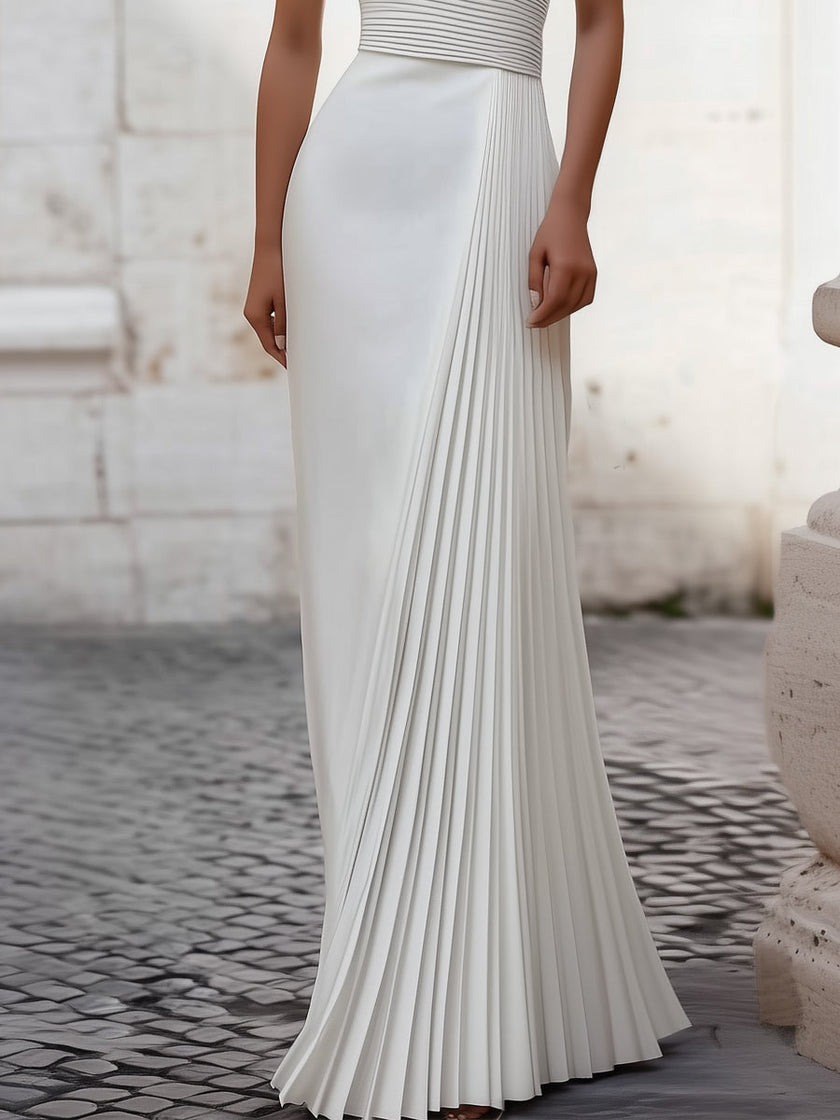 White satin pleated halter evening gown by FJØRNA featuring elegant design, perfect for black tie events and formal occasions.
