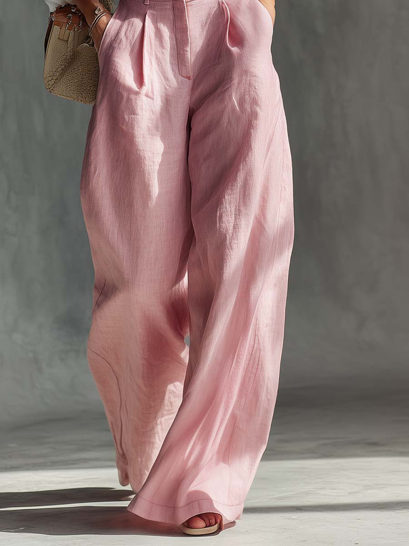 Pink cotton linen wide-leg women's dungarees by FJØRNA, showing relaxed fit and adjustable straps on lightweight fabric.