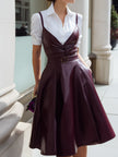 White shirt dress with wine-red leather suspender set by FJØRNA, featuring a stylish leather dress look.