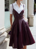White shirt dress with wine-red leather suspender set by FJØRNA, featuring a stylish leather dress look.