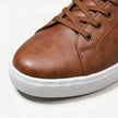 FJØRNA men's leather lace-up low top sneakers with sleek design, black leather upper, and white rubber sole.