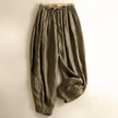 FJØRNA women's linen tapered trousers, lightweight pants with relaxed fit, featuring side pockets and a high waist.