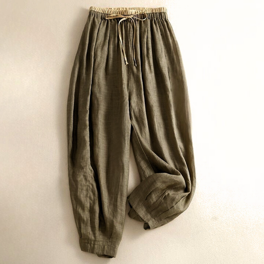 FJØRNA women's linen tapered trousers, lightweight pants with relaxed fit, featuring side pockets and a high waist.