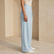 Women's loose pull-on wide-leg trousers with criss-cross waist detail from FJØRNA, showcasing relaxed fit and comfortable style.