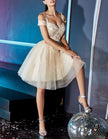 FJØRNA champagne tulle cocktail dress for women, off-shoulder design with elegant, flowing fabric and intricate detailing.