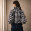 FJØRNA women's gingham ruffle oversized long sleeve blouse, stylish top with ruffle details and relaxed fit, in a classic pattern.
