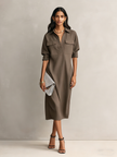 FJØRNA black linen midi dress featuring a flowing evening dress design, with a fitted bodice and elegant midi length.