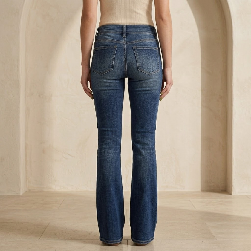 Women's mid-waist slim-fit flared stretch jeans by FJØRNA, showing their fit and flared style on a model.