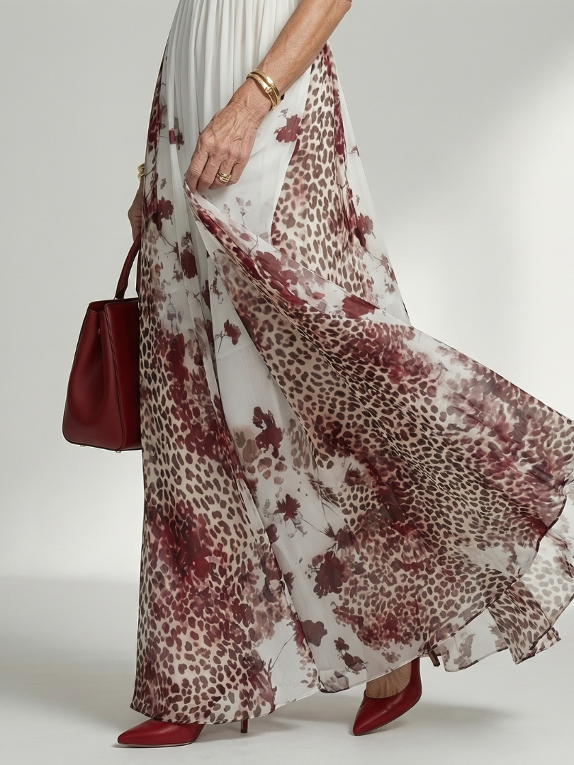 FJØRNA women's summer maxi dress with floral print, long sleeves, and pleated design, flowing fabric perfect for warm weather.