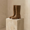 FJØRNA tan knee-high leather winter boots with block heels for women, featuring a stylish and warm design for winter footwear.