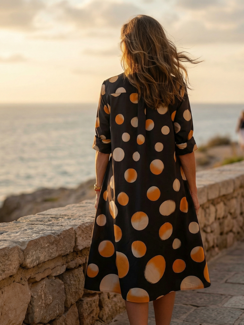FJØRNA women's summer dress with polka dots, pockets, lightweight casual style, perfect for warm weather, shown hanging on a hanger.