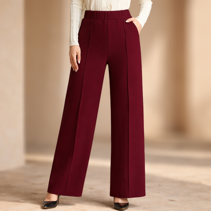 FJØRNA women's high-waist wide-leg tailored trousers with a loose pull-on design, in a neutral color, shown on a model.