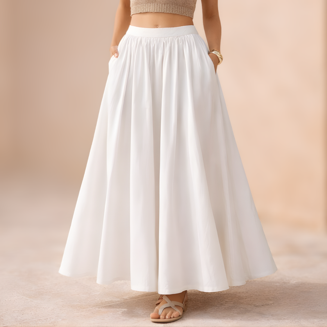 FJØRNA white high-waist A-line maxi skirt for women, flowing long skirt with a fitted waistband and elegant silhouette.
