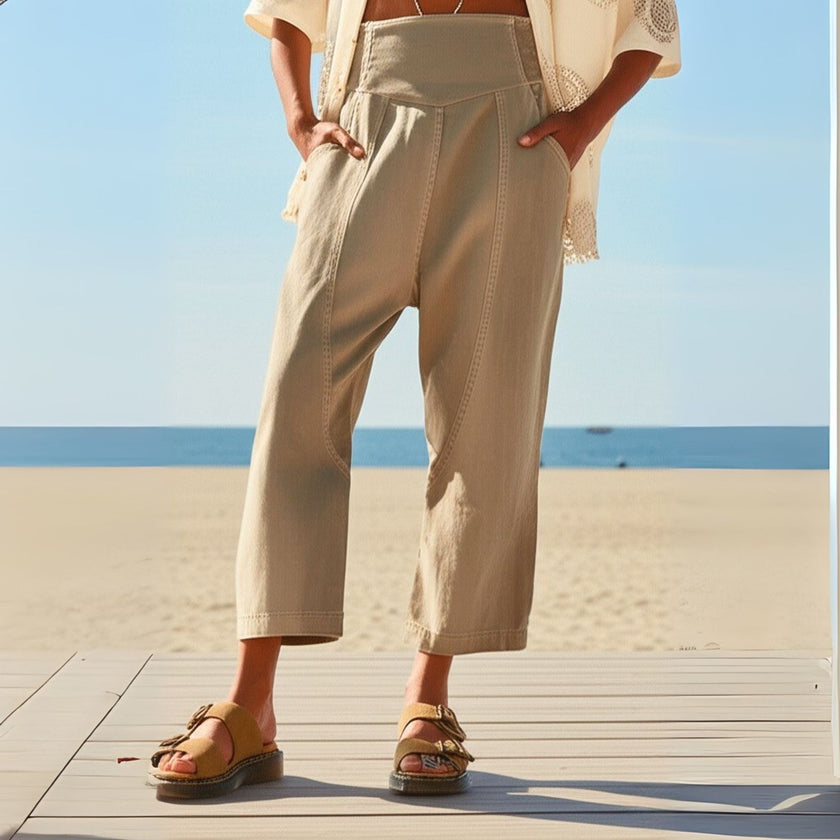 FJØRNA women's wide-leg denim trousers, stylish pants with relaxed fit and classic blue denim fabric, front view.