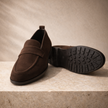 FJØRNA men's leather penny loafers, classic slip-on shoes in brown with smooth leather finish and subtle stitching details.