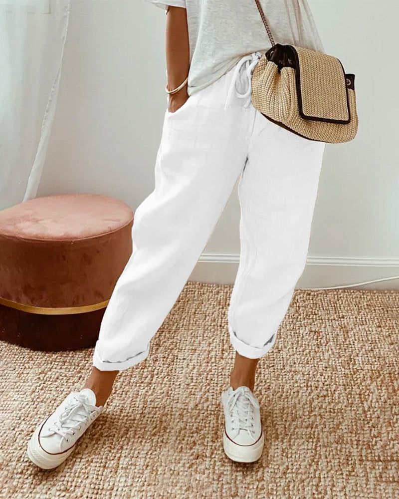 FJØRNA women's lightweight summer trousers with straight leg and high waist, shown in soft fabric and neutral color.