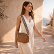FJØRNA black leather shoulder bag for women with sleek design and shoulder strap, crafted from refined leather.
