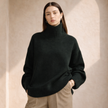 FJØRNA women's wool turtleneck sweater in neutral color, showcasing its cozy knit and classic fit.