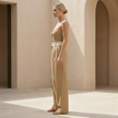 FJØRNA pinstripe strapless wide-leg jumpsuit for women, perfect as a wedding guest outfit, featuring a stylish strapless design.
