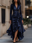 Navy blue satin maxi dress with draped ruffle details by FJØRNA, featuring flowing fabric and elegant design.