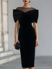 FJØRNA black velvet bow midi dress featuring a fitted silhouette and elegant bow detail at the waist.