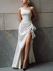 FJØRNA white one-shoulder satin gown with front slit, elegant black tie dress, featuring draped design and sleek silhouette.