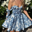 Blue floral off-shoulder mini dress by FJØRNA, perfect for elegant party wear with a stylish floral pattern and feminine design.