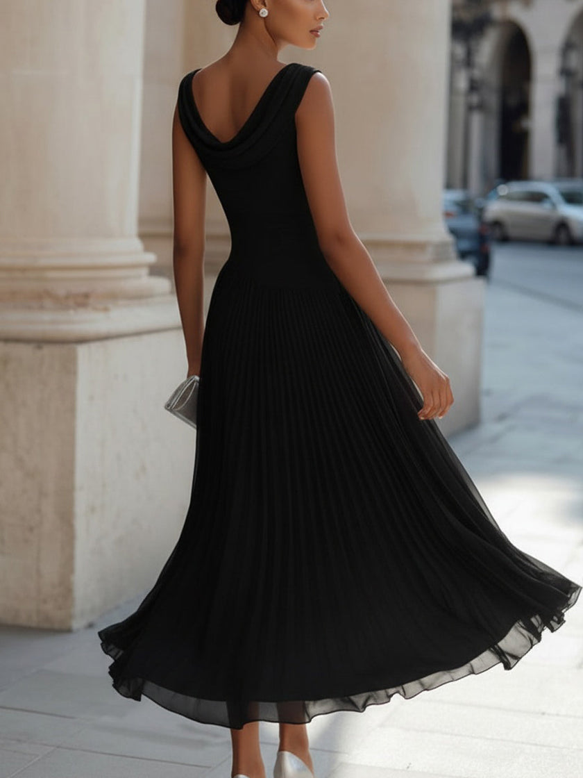 FJØRNA draped neck sleeveless pleated midi dress, perfect for wedding guest attire, shown on a model with flowing fabric and elegant design.