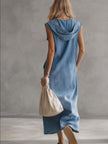 Blue denim V-neck midi dress by FJØRNA, casual dress featuring a fitted waist and knee-length hem, displayed on a hanger.