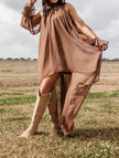 FJØRNA women's sleeveless maxi dress featuring a halter neckline and asymmetric hem, perfect for elegant summer occasions.
