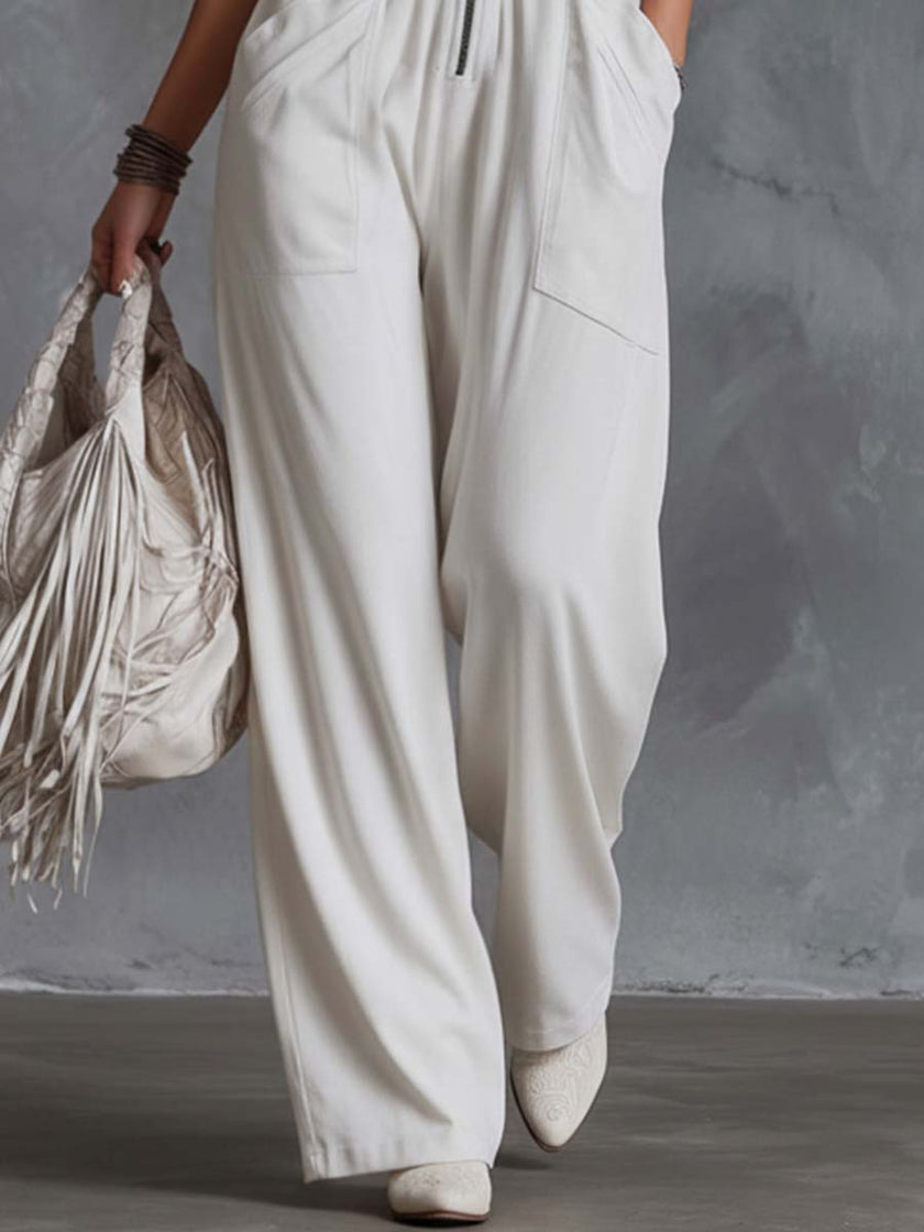 White faux suede Western fringe V-neck jumpsuit for women, featuring fringe details and a stylish V-neck design.