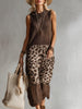 Brown knit leopard print maxi dress by FJØRNA, featuring long sleeves and a flowing silhouette for elegant evening wear.