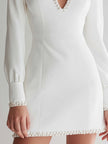 White long-sleeve pearl keyhole mini dress for women by FJØRNA, featuring a stylish design with pearl accents and a keyhole neckline.