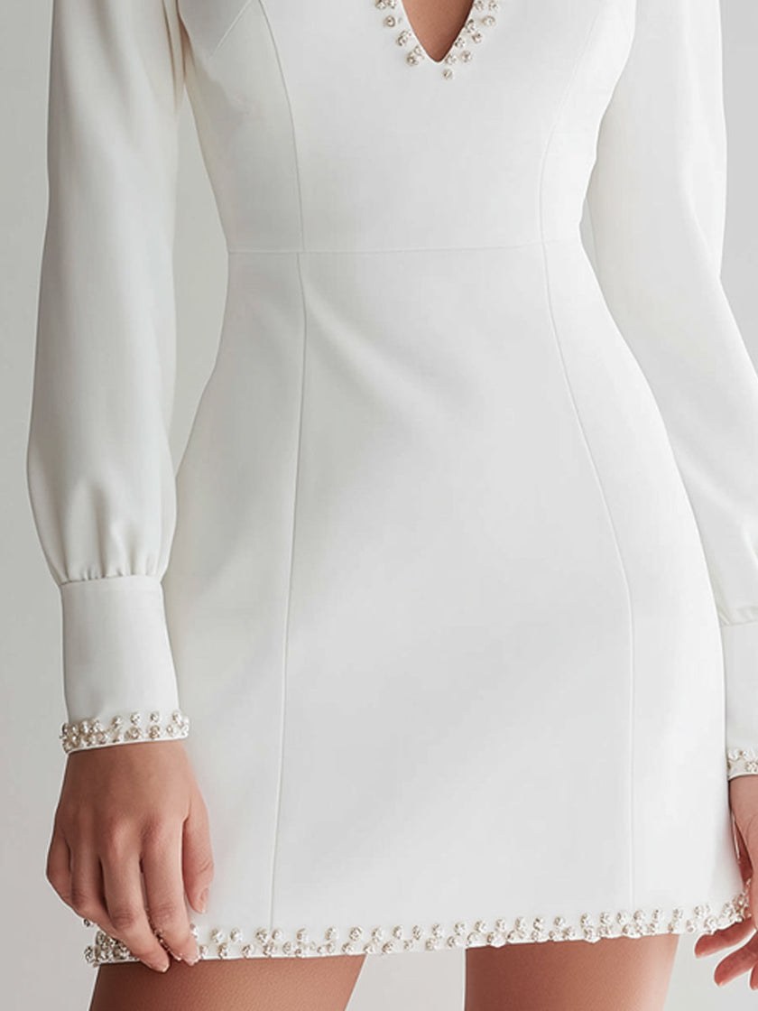 White long-sleeve pearl keyhole mini dress for women by FJØRNA, featuring a stylish design with pearl accents and a keyhole neckline.