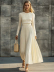 Cream satin pleated maxi dress by FJØRNA featuring a flowing design and elegant pleats, perfect for casual or dressy occasions.