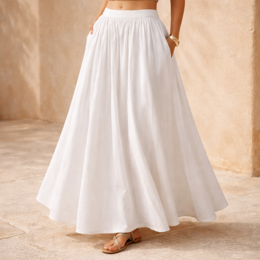 FJØRNA white high-waist A-line maxi skirt for women, flowing and elegant, styled as a long maxi skirt in the image.