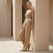 FJØRNA pinstripe strapless wide-leg jumpsuit for women, perfect as a wedding guest outfit, featuring a stylish strapless design and relaxed fit.