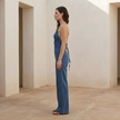 FJØRNA denim wide-leg jumpsuit for women with tie-back detail, stylish women’s set made from durable denim fabric.