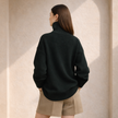 FJØRNA women's wool turtleneck sweater, cozy knit with ribbed collar and cuffs, in a neutral color, perfect for cold weather.
