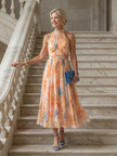 FJØRNA women's summer midi dress with halter neck and sleeveless design, flowing fabric perfect for warm weather.