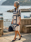 FJØRNA women's summer dress featuring a geometric wrap design, lightweight fabric, and stylish silhouette for warm weather.