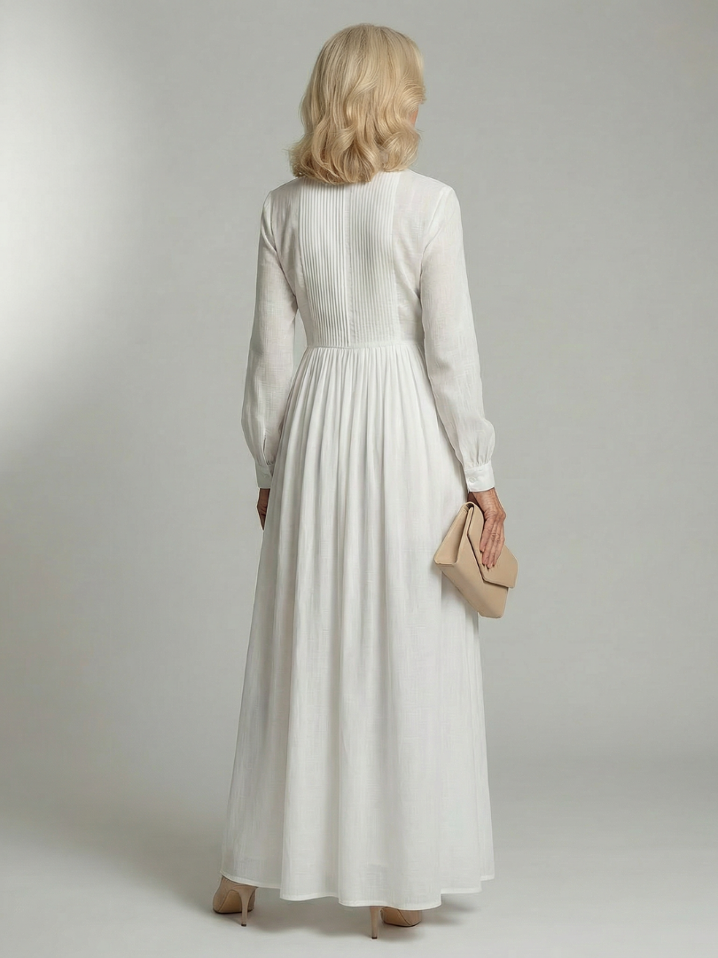 FJØRNA women's summer maxi dress with long sleeves and pockets, flowing fabric, and a relaxed fit for warm weather wear.