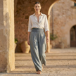 FJØRNA white high waist wide leg pants for women, showcasing smooth fabric and relaxed fit, styled with a casual top.
