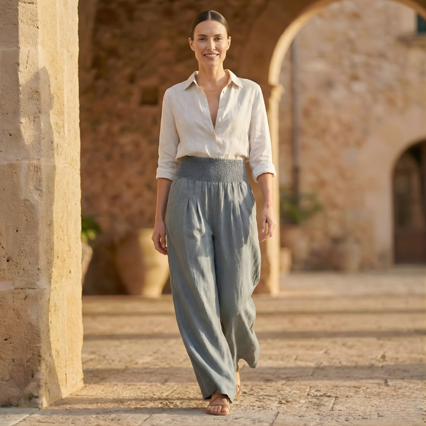 FJØRNA white high waist wide leg pants for women, showcasing smooth fabric and relaxed fit, styled with a casual top.