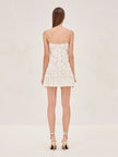 White FJØRNA Rosette Georgette mini dress with frills, ideal for wedding guests, featuring delicate rosette detailing and flowing fabric.